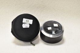 A modern magnifier with integrated light and case.