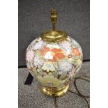 A large Chinese ceramic lamp base having brass base and fittings, with gilt ground and design of