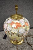 A large Chinese ceramic lamp base having brass base and fittings, with gilt ground and design of