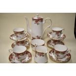 A Royal Stafford bone china partial coffee service, having white ground with rambling rose