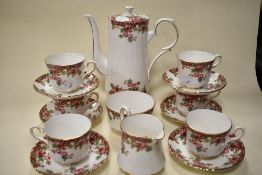 A Royal Stafford bone china partial coffee service, having white ground with rambling rose