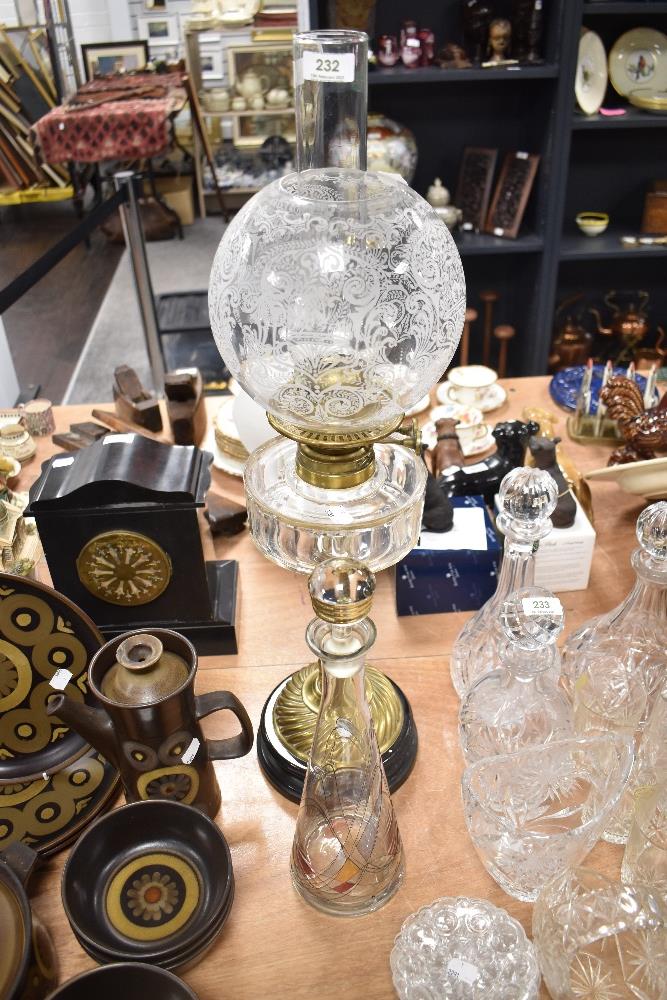 An impressive Victorian oil lamp, having etched glass globular shade, clear faceted reservoir and