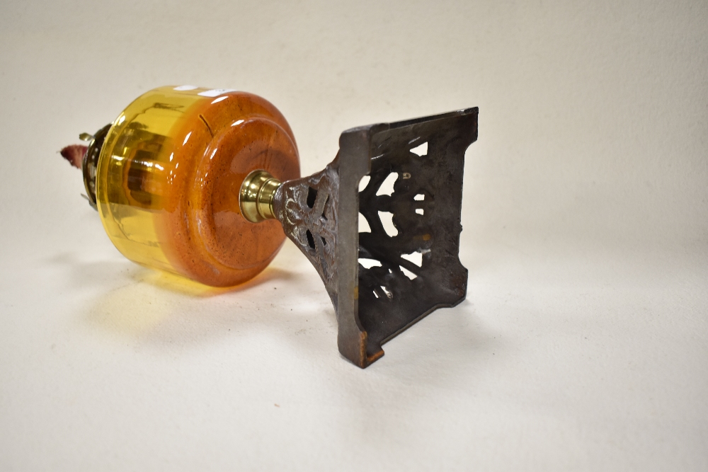 A late 19th/early 20th century oil lamp, having cast metal base with anchor design, amber glass - Image 2 of 3