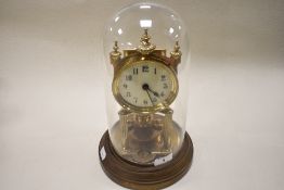 An early 20th century brass 400 day anniversary clock, having enamel face and glass dome,