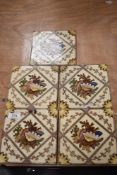 Five Victorian tiles, having colourful shell transfer pattern within a diamond, with motifs to