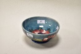 A Mid century Moorcroft pottery bowl having teal blue ground with tube lined Anemone design in