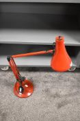 A vintage red 'Anglepoise' lamp.