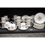 A collection of cups, saucers and side plates, having blue floral transfer pattern on white