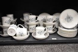 A collection of cups, saucers and side plates, having blue floral transfer pattern on white