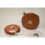 Two vintage leather bound tape measures, marked Rabone Chesterman Ltd with brass winders.