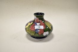 A mid century Moorcroft pottery Hibiscus pattern vase of squat form, having tube lined Hibiscus