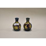 Two circa 1960s Moorcroft Hibiscus ware bud vases, having tubelined Hibiscus design to blue and