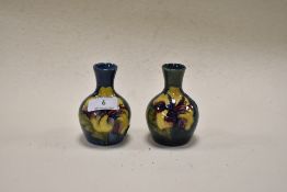 Two circa 1960s Moorcroft Hibiscus ware bud vases, having tubelined Hibiscus design to blue and