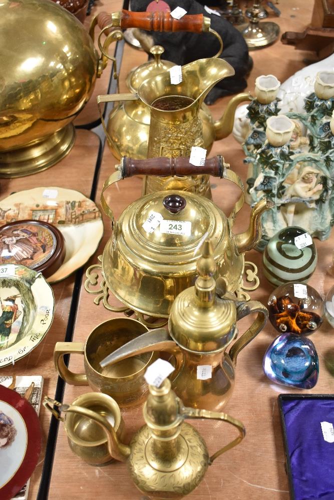 A varied lot of brass ware, kettles, Middle Eastern Dallah coffee pot, chase work cups and more.