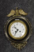 A French 1900 dated metal wall clock having brass eagle finial, beading and floral bracketry to