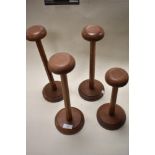 Four vintage mahogany wig stands.