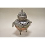 A 20th century Tibetan copper and white metal incense burner having raised relief and pierced