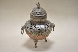 A 20th century Tibetan copper and white metal incense burner having raised relief and pierced