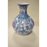 A large 20th century vase of baluster form, having pale blue and pink floral decoration on white