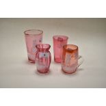 Four late 19th century cranberry glass wares, overlaid in the Mary Gregory style, including two