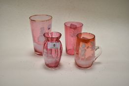 Four late 19th century cranberry glass wares, overlaid in the Mary Gregory style, including two