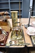 A collection of vintage brass ware, including embossed umbrella stand, candlesticks, horse