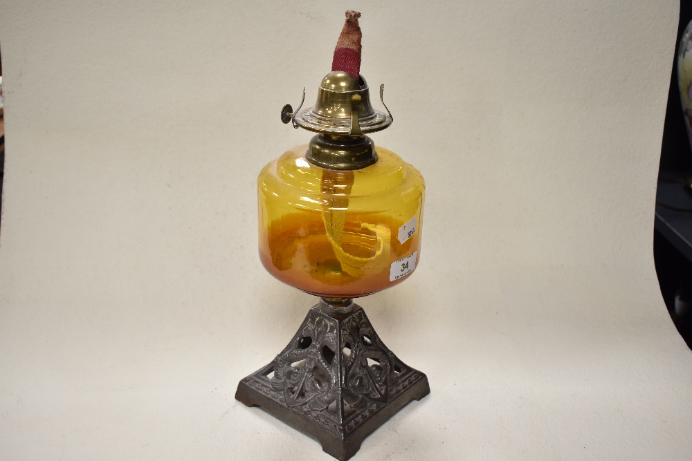 A late 19th/early 20th century oil lamp, having cast metal base with anchor design, amber glass - Image 3 of 3