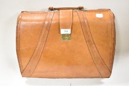 A vintage style tan leather brief case.