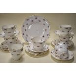 A collection of Adderley bone china 'Floral' cups, saucers, jug and cake plate.