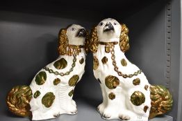 A pair of 19th century Staffordshire flat back dogs, having lustre and gilt heightening.