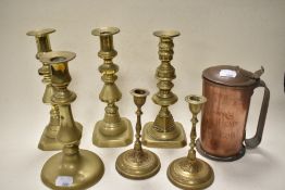 Six brass candlesticks and a copper tankard with hinged lid inscribed with ' Skippers head,