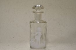 A 20th century clear glass perfume bottle having faceted stopper and white enamel decoration in