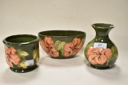 A trio of Moorcroft pottery Hibiscus wares, to include planter, bowl and squat baluster vase, all