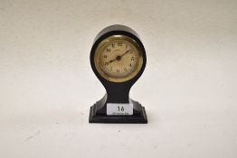 An early 20th century ebonised balloon form alarm clock.