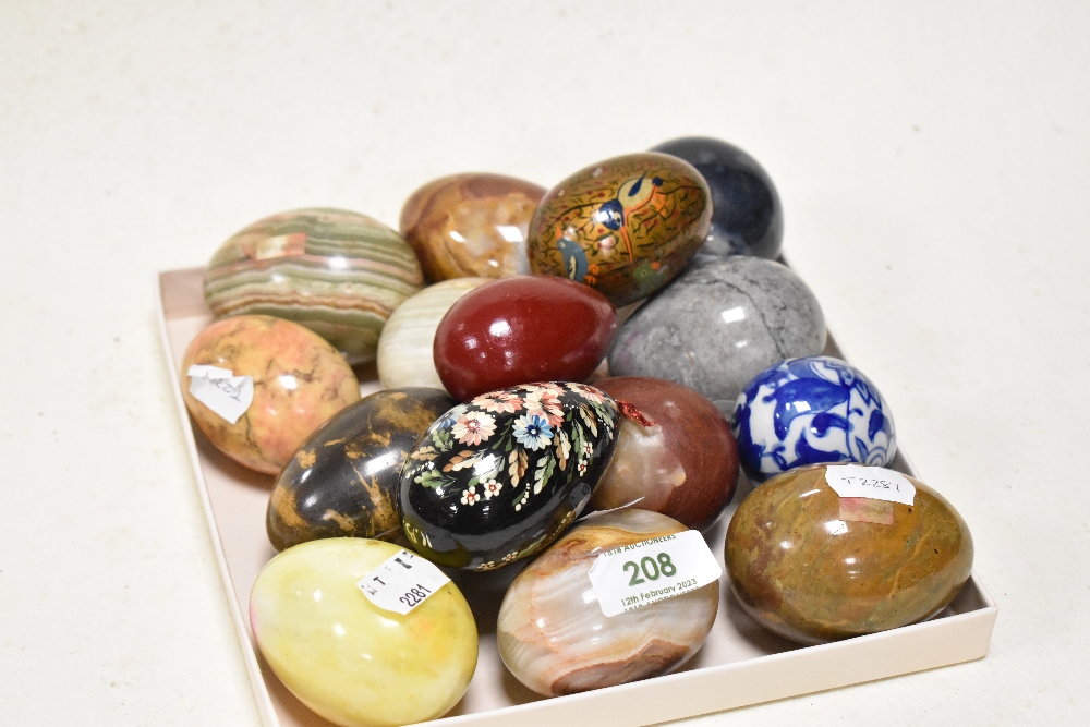 A collection of natural stone and painted wood eggs, including marble and onyx.