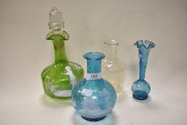 Four late 19th century Mary Gregory style items of blue, green and clear glass, comprising decanter,