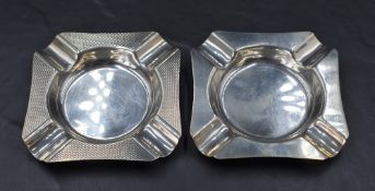 A near pair of Queen Elizabeth II silver ashtrays, of canted square form with moulded rests to