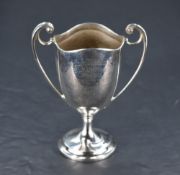 A small George V silver two-handled trophy, having waved rim and tapering body engraved with