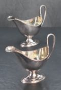 A pair of Elizabeth II silver gravy boats, of classical design with reeded edge detail and loop