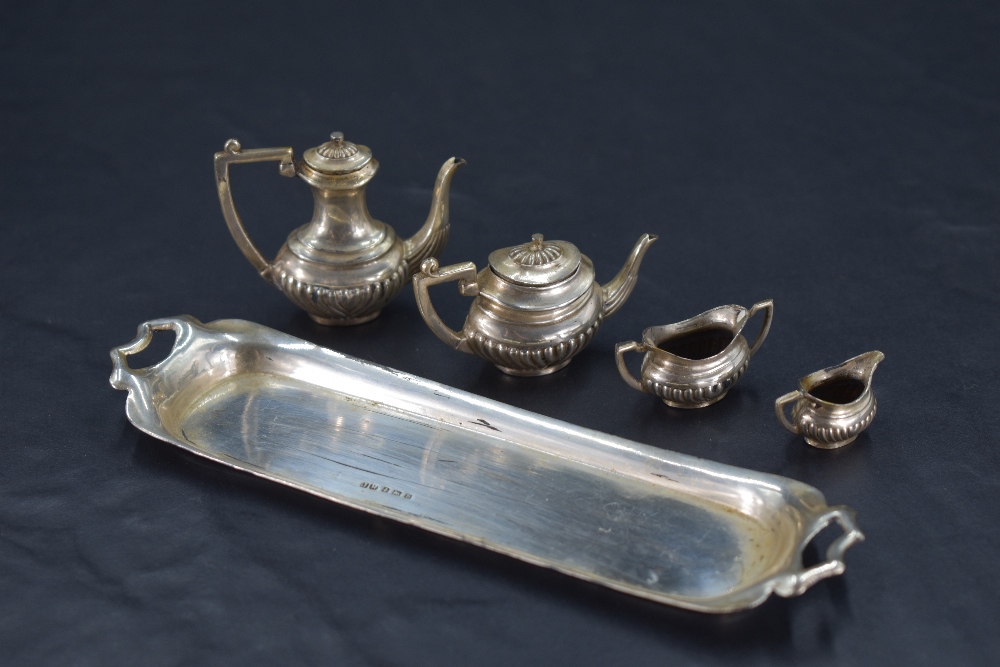 A miniature five-piece silver teaset, of half gadrooned oval baluster form, comprising teapot, - Image 2 of 2