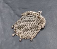 An Art Nouveau white metal and mesh coin purse, the clasp with stylised foliate design, unmarked,