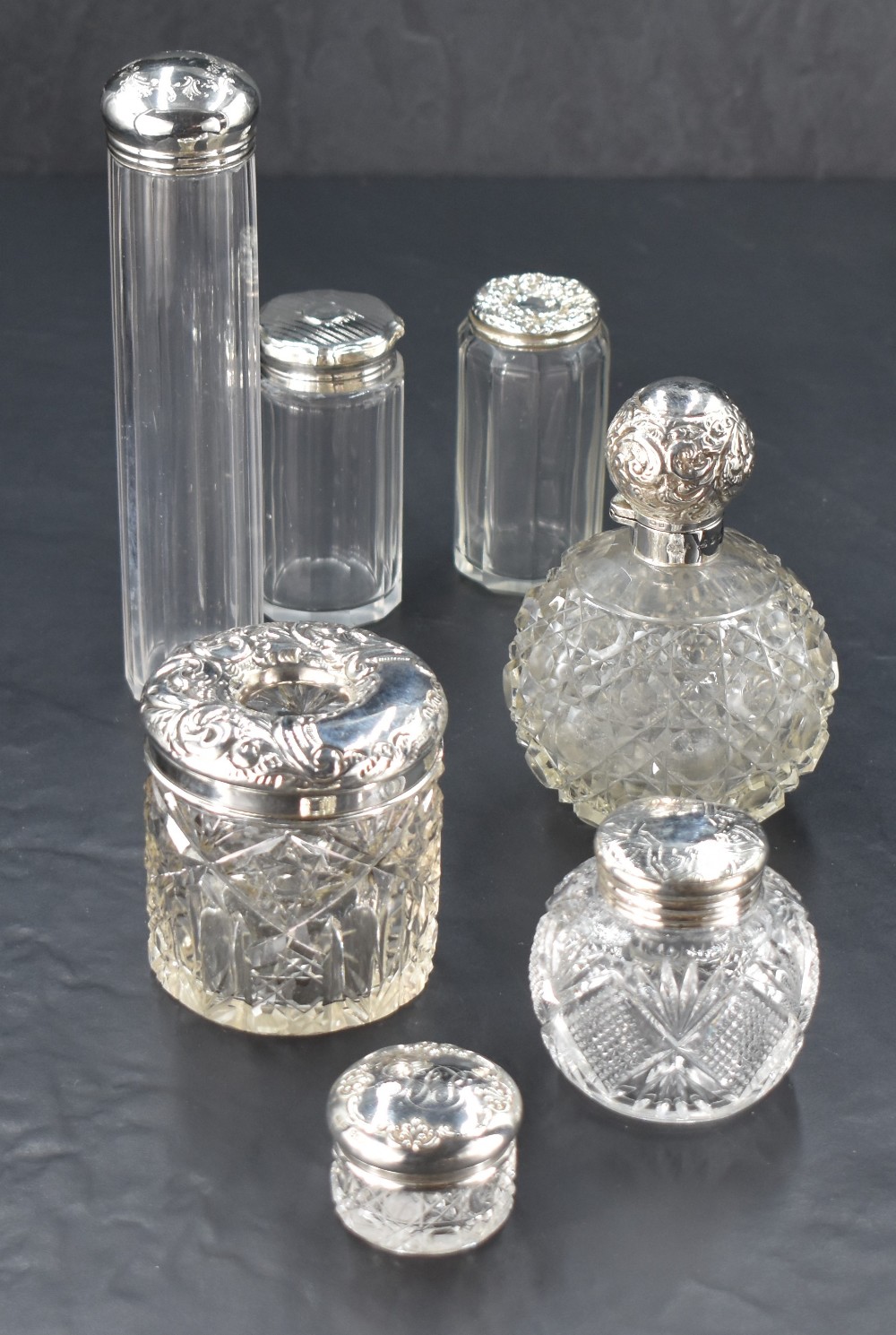 A selection of silver mounted cut-glass dressing table wares, comprising scent bottle, hair tidy,