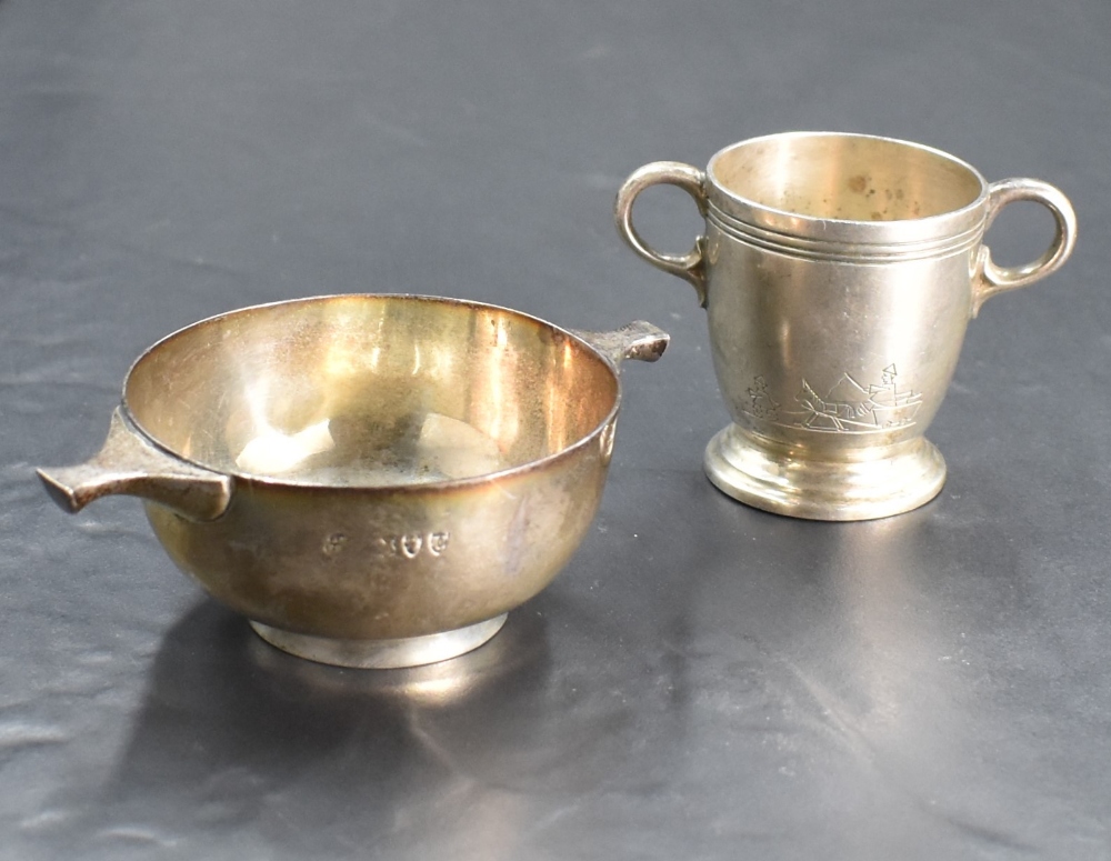 A 1940's silver two-handled egg cup, of tapering cylindrical form engraved with simplistic