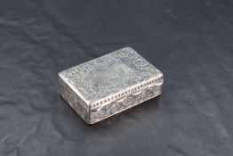 A late Victorian silver box, of rectangular form with profuse foliate scroll decoration centred by