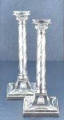 A fine pair of Victorian silver plated column candlesticks, the removable re-entrant square sconce