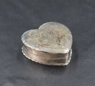 A George V silver heart-shaped pill box, engraved with ribbon and swags, marks for Birmingham