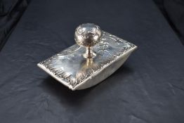 A Portuguese silver mounted ink blotter, of traditional design embossed with scrolls and foliate
