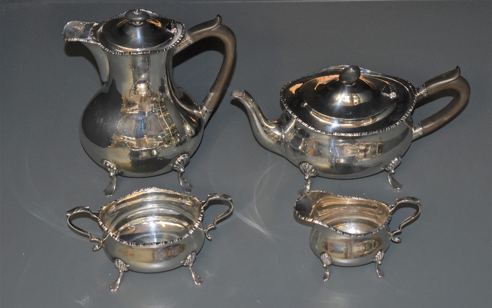 An Edwardian silver four-piece teaset, of oblong baluster form with moulded edge detail and scrolled