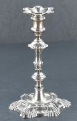 A George II cast-silver candlestick, of traditional knopped design with moulded scallop, fluted