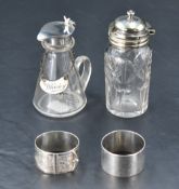A George V silver mounted glass oil/vinegar bottle, silver whisky label, silver napkin ring, white